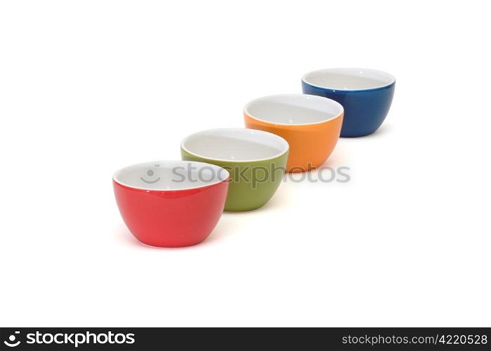 Diagonal row of four porcelain bowls isolated on white background