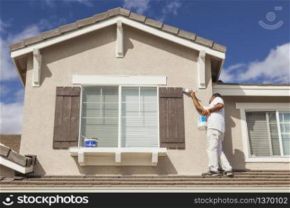 Diagonal Split Screen of Drawing and Photo of Busy House Painter Painting Home.