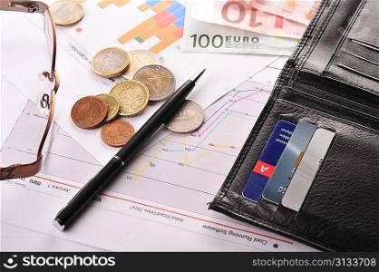 diagramme, credit cards and purse on table