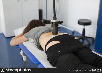 Diamagnetic Pump for Pain Therapy: Woman lying on aBed Undergoing Therapy.. Diamagnetic Pump for Pain Therapy: Woman lying on aBed Undergoing Therapy