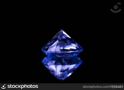 diamond with blue tones reflecting in a crystal on a black background