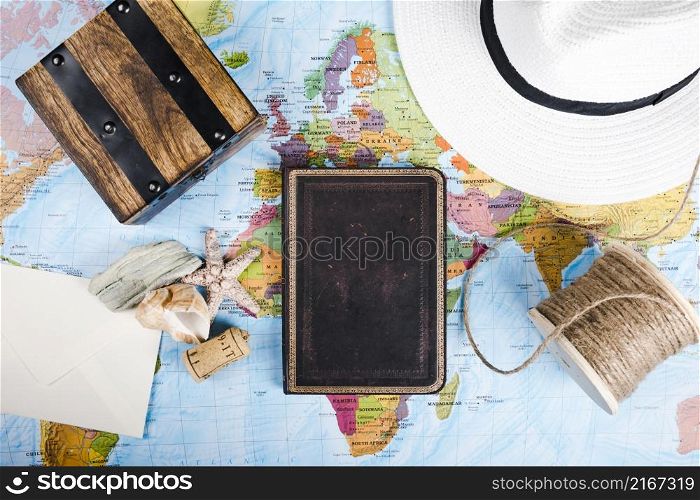 diary sea shell hat wooden box spool world map