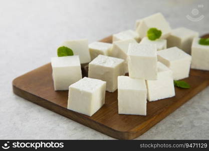 Diced Paneer or cottage cheese with green leaves. 