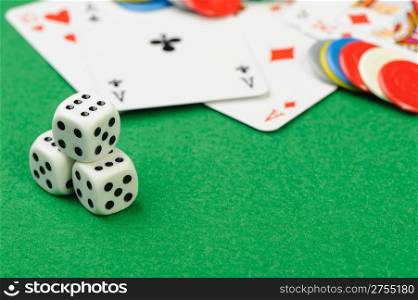 dices and playing cards. Game cubes and Playing cards on a green background