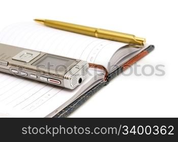 Dictaphone, notepad and ballpen isolated on white background