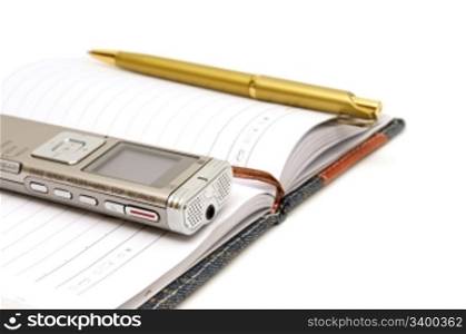 Dictaphone, notepad and ballpen isolated on white background