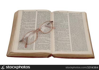 dictionary and a pair of glasses isolated on a white background