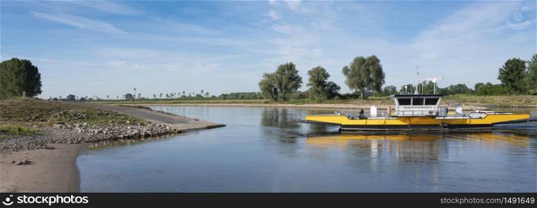 Dieren, Netherlands, 2 june 2020: yellow ferry on river ijssel between olburgen and dieren in the netherlands