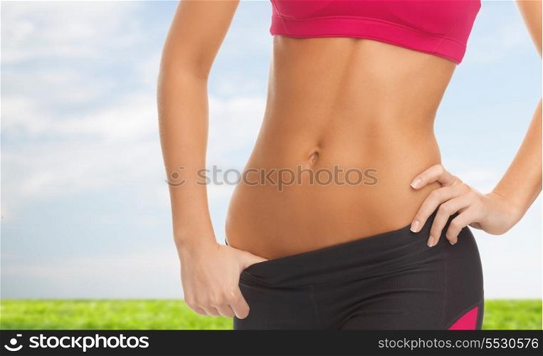 diet and fitness concept - close up picture of woman trained abs