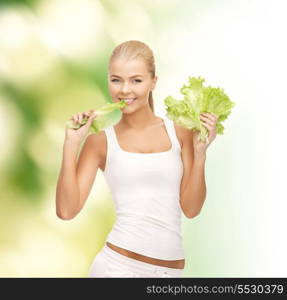 diet and fitness concept - healthy woman biting piece of lettuce