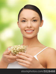 diet and healh concept - healthy woman holding bowl with sprout