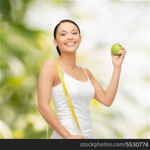 diet and health concept - beautiful sporty woman with apple and measuring tape