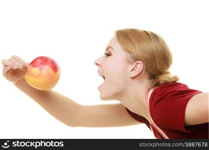 Diet and nutrition. Funny housewife or chef in striped kitchen apron eating red apple healthy fruit isolated