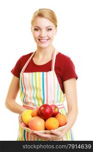 Diet and nutrition. Happy housewife or chef in striped kitchen apron offering healthy fruit isolated