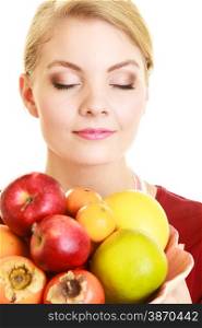 Diet and nutrition. Happy housewife or chef offering healthy fruit closed eyes smelling isolated