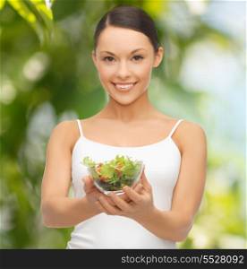 diet and sport concept - healthy woman holding bowl with salad