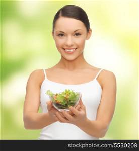 diet and sport concept - healthy woman holding bowl with salad