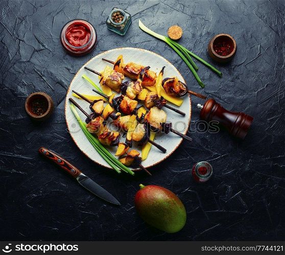 Diet chicken skewer with ripe mango. Shashlik, top view. Chicken kebabs, skewered chicken