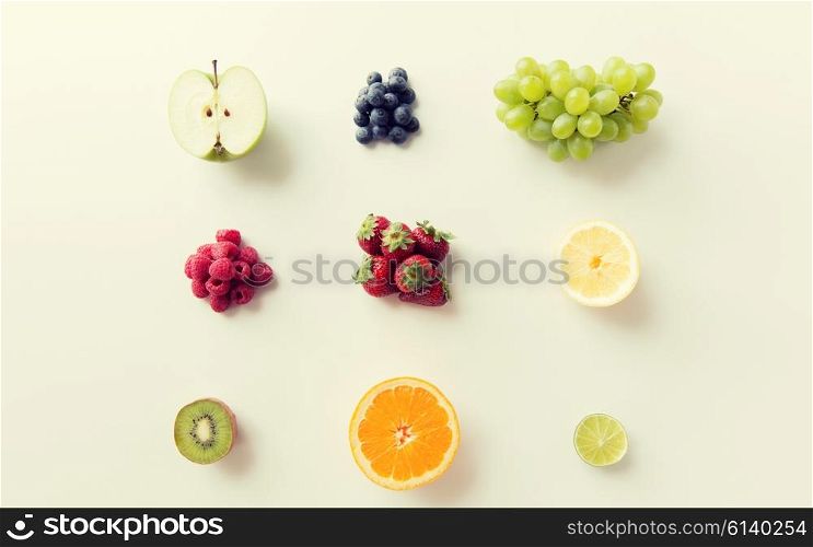 diet, eco food, healthy eating and objects concept - ripe fruits and berries on white surface