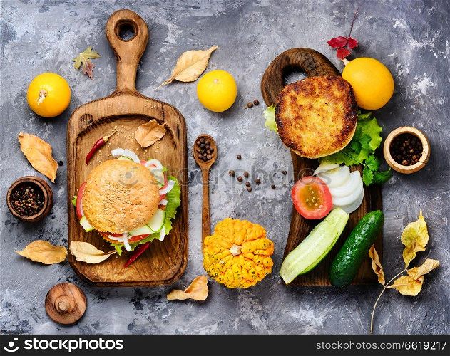 Diet hamburger with fresh vegetables and pumpkin cutlet.Appetizing squash burgers.Autumn menu. Diet hamburger with vegetables