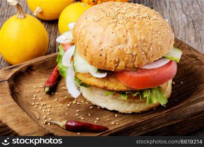 Diet hamburger with fresh vegetables and pumpkin cutlet.Appetizing squash burgers. Diet hamburger with vegetables