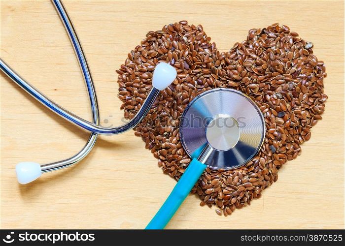 Diet healthcare and checkup concept. Raw flax seeds linseed heart shaped and stethoscope. Healthy food for preventing heart diseases.
