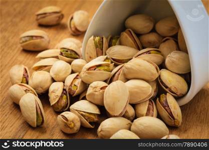 Diet healthcare concept. Roasted pistachio nuts seed with shell close up