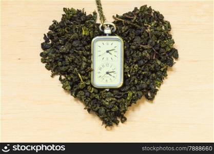 Diet healthcare tea time concept. Green tea heart shaped on wooden surface. Healthy food drink for lower heart disease risk