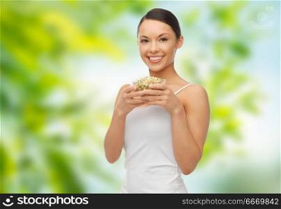 diet, healthy eating and people concept - happy slim woman with mung bean sprouts over green natural background. happy slim woman with mung bean sprouts. happy slim woman with mung bean sprouts