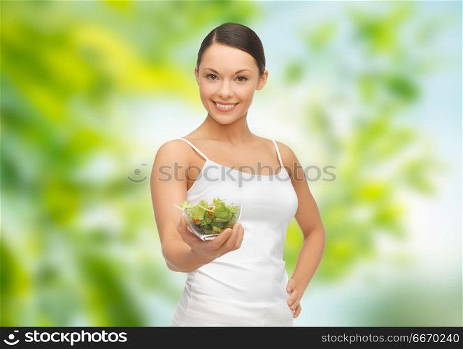 diet, healthy eating and people concept - happy slim woman with vegetable salad over green natural background. happy slim woman with vegetable salad. happy slim woman with vegetable salad