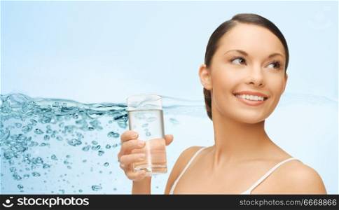 diet, healthy eating and people concept - woman with glass of water over blue background. woman with glass of water over blue background. woman with glass of water over blue background