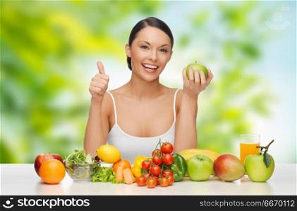 diet, healthy eating and people concept - woman with green apple and vegetable showing thumbs up over green natural background. woman with vegetable food showing thumbs up. woman with vegetable food showing thumbs up