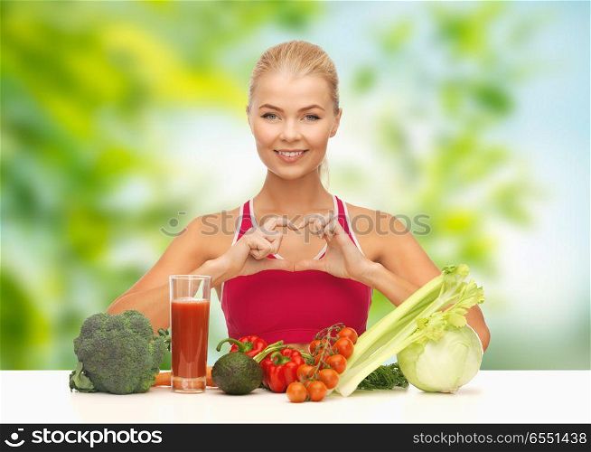 diet, healthy eating and people concept - woman with vegetable food and drink showing hand heart gesture over green natural background. woman with vegetables and drink showing hand heart. woman with vegetables and drink showing hand heart