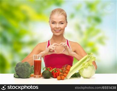 diet, healthy eating and people concept - woman with vegetable food and drink showing hand heart gesture over green natural background. woman with vegetables and drink showing hand heart. woman with vegetables and drink showing hand heart
