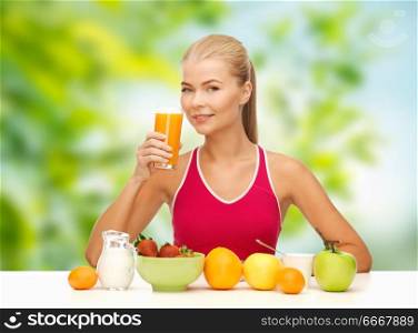 diet, healthy food and people concept - woman drinking fruit juice for breakfast over green natural background. woman drinking fruit juice for breakfast. woman drinking fruit juice for breakfast