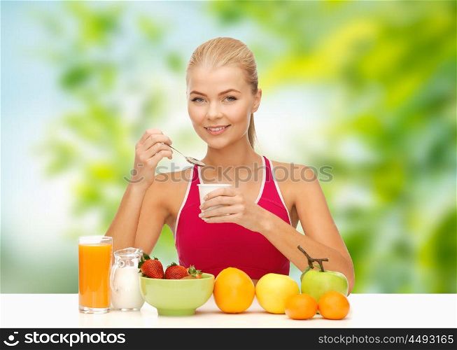 diet, healthy food and people concept - woman with fruits eating yogurt for breakfast over green natural background. woman with fruits eating yogurt for breakfast. woman with fruits eating yogurt for breakfast