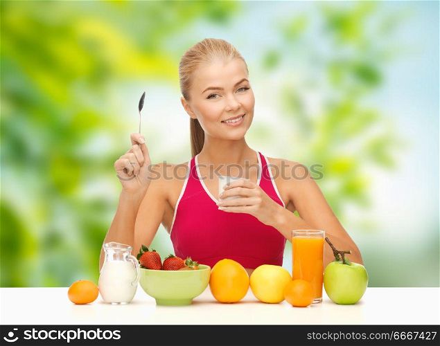 diet, healthy food and people concept - woman with fruits eating yogurt for breakfast over green natural background. woman with fruits eating yogurt for breakfast. woman with fruits eating yogurt for breakfast
