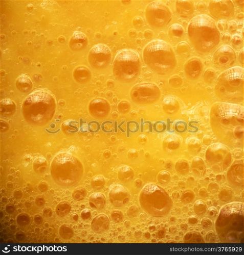 Diet healthy nutrition. Fresh yellow fruits juice background texture. Orange water bubbles. Macro Square format