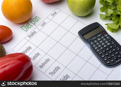 Diet plan sheet and fresh food on white background. Top view, the concept of healthy eating.. Diet plan sheet and fresh food on white background.