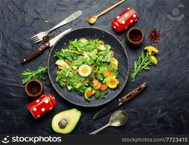 Diet salad with chrysanthemum leaves,avocado,carrots and green.Fresh summer salad with edible flowers. Spring salad with chrysanthemum leaves and avocado