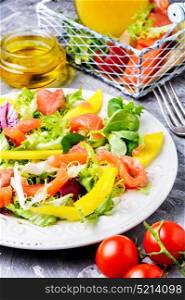 Diet salad with salmon,mango and fresh lettuce. Fish salad with salmon and vegetables