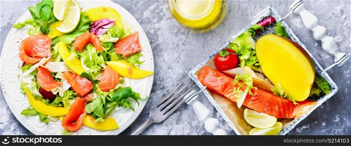Diet salad with salmon,mango and fresh lettuce. lettuce salad with fish