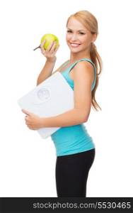 diet, sport and healthcare concept - beautiful sporty woman with scale and green apple