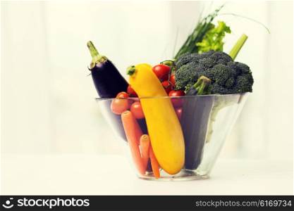 diet, vegetable food, healthy eating and objects concept - close up of ripe vegetables in glass bowl on table