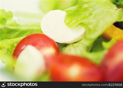 diet, vegetable food, healthy eating and objects concept - close up of vegetable salad with mozzarella cheese