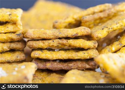 Dietary food made from wheat flour and various vegetables close-up of crackers folded in a pile. Dietary food