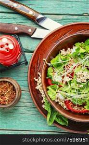 Dietary salad with sprouted green buckwheat, celery, tomato and microgreens.Bowl of vegetable salad. Healthy vegetable salad