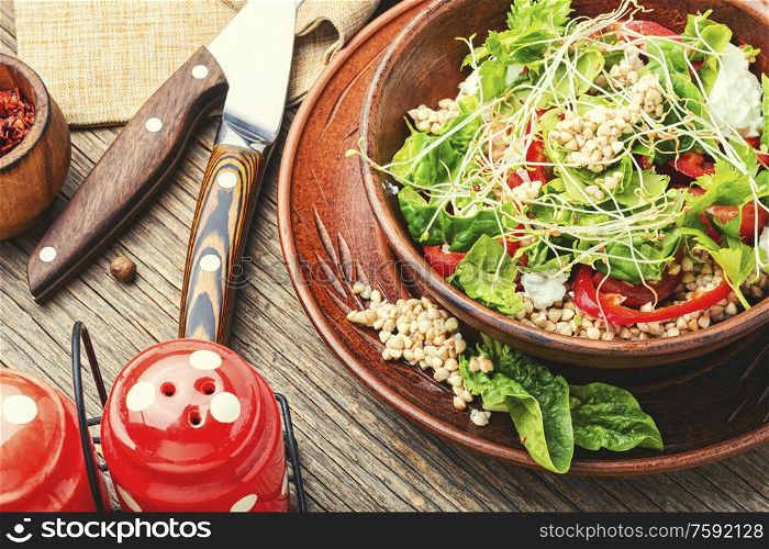 Dietary salad with sprouted green buckwheat, celery, tomato and microgreens.. Vegetables salad of buckwheat
