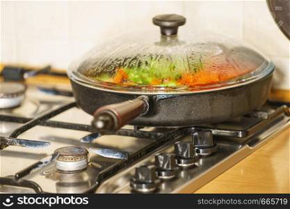 Dieting eating, preparing food concept. Many chopped healthy vegetables on frying pan, vegetarian meal preparation.. Chopped vegetables on frying pan