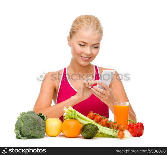 dieting, food, healthcare and technology concept - smiling sporty woman with fruits and vegetables counting calories in smartphone